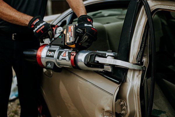 Firemen opening fire truck side panel
