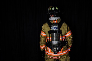 Firemen opening fire truck side panel